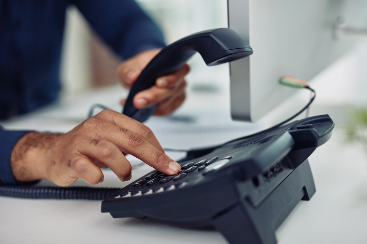 Closeup shot of unrecognizable businessman using a telephone in an office